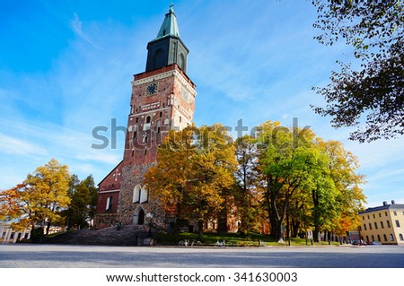 Turku Cathedral, is the Mother Church of the Evangelical Lutheran Church of Finland. It is also regarded as one of the major records of Finnish architectural history. Colorful autumn and blue sky. Royalty-Free Stock Photo #341630003