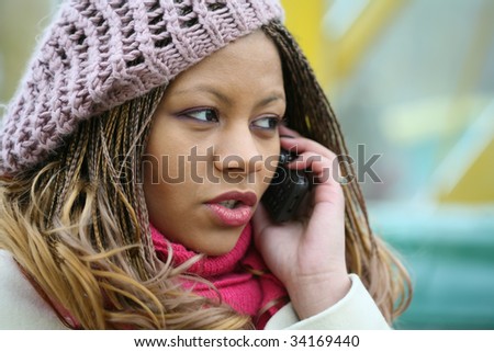woman in lilac beret is talking on mobile phone