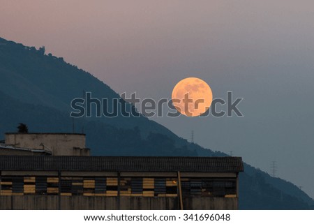 Beautiful, colorful moonrise at sunset behind the Avila mountain, in Caracas, Venezuela