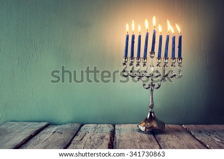 low key and vintage filtered image of jewish holiday Hanukkah with menorah (traditional Candelabra)