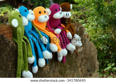 Amazing scene with group of knitted monkey climb tree, 2016 is year of the monkeys, monkey symbol in colorful yarn to happy new year