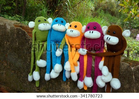 Amazing scene with group of knitted monkey climb tree, 2016 is year of the monkeys, monkey symbol in colorful yarn to happy new year