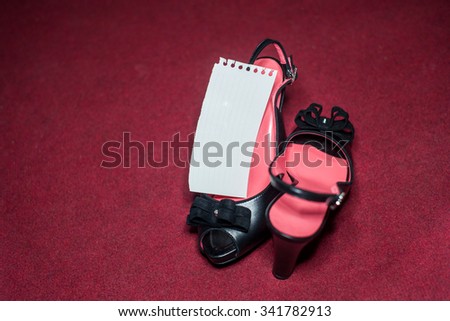 black shoes on a floor with paper label
