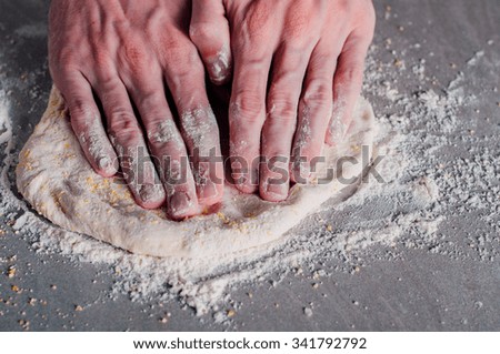 Man chef making dough for pizza Margherita