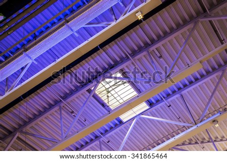 Modern building interior ceiling with struts and window using a diagonal composition