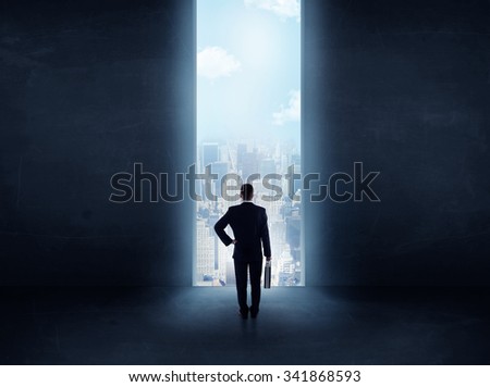businessman standing in front of the huge gate