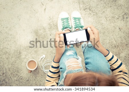 woman holding phone white screen on top view vintage style Royalty-Free Stock Photo #341894534
