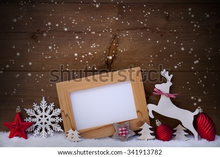 Christmas Card With Picture Frame On Snow. Copy Space For Advertisement. Red Christmas Decoration Like Christmas Ball, Snowflakes, Tree, Star And Reindeer. Wooden And Vintage Background