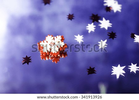 Christmas snowflakes and little stars on a blue background.