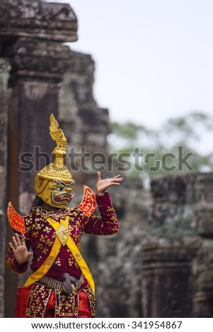 Hindu cultural legend of deity with hands gestures reenacting by an actor in colorful costume at Bayon temple ruins, Angkor Wat, Siem Reap