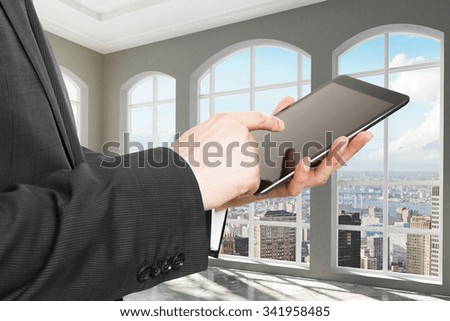 Businessman with digital tablet in sunny loft room with city view 3D Render