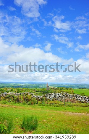 Panorama view of Bodmin Moor on a beautiful cloudy blue sky Summer day, the ruins of a Cornish Tin Mine the Phoenix United Mines Prince of Wales Engine House can be seen in the distance, Cornwall, U K