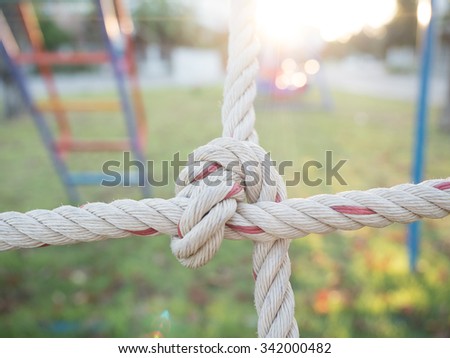 close up image of climbing net for childrens at the playground.it tied together securely.