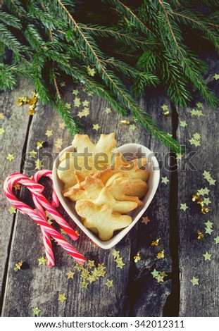 Christmas cookies and candies on wooden surface