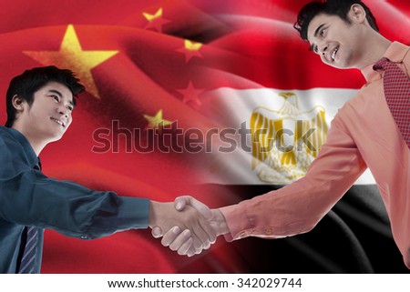 Image of two workers shaking hands with flag of China and Egypt