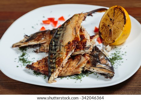 Roasted sea fish with vegetables barbecue sauce. Tasty Mediterranean food. Dish professional kitchen. Beautiful exhibition dish on a white plate. Photo for culinary magazines, posters and websites.