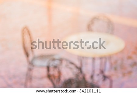 blur image of table and chait outdoor for background usage.