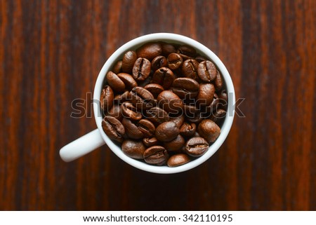 coffee grains in a white mug on a table