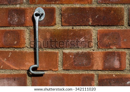 Door hook hanging on a brick wall