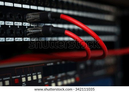 A pair of red audio cables plugged in