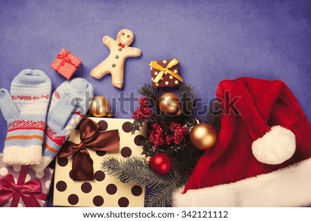 Gingerbread man and Christmas gifts on blue background