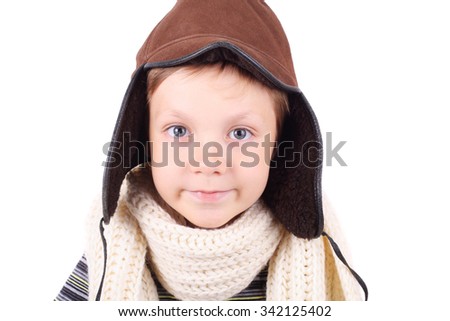 cute smiling little boy wearing winter cap and scarf