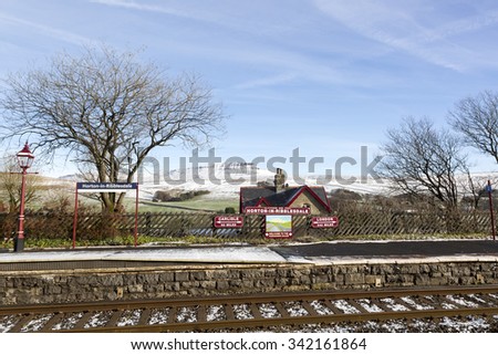 Horton in Ribblesdale station, with a snow covered Pen-y-ghent in the background Royalty-Free Stock Photo #342161864