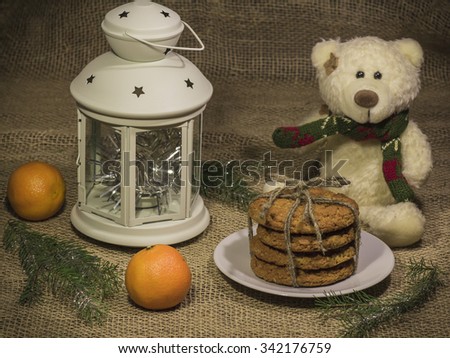 A Christmas still life. White lantern standing on the table, a toy polar bear sits next to a lantern.