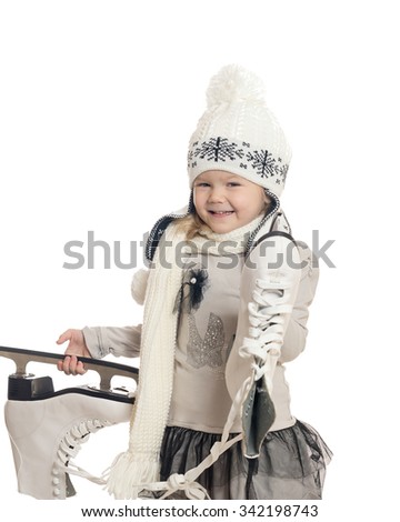 The little girl holds skates and rejoices