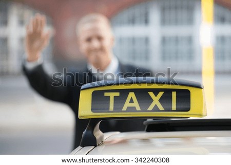 Close-up Of A Taxi In Front Of Young Businessman