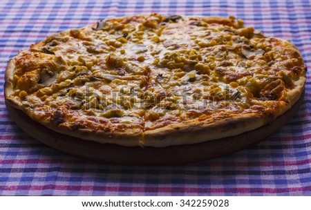 Delicious supreme hot pizza with bacon and sweet corn ready to eat