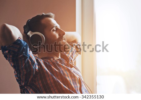 handsome bearded man  in headphones listening to music Royalty-Free Stock Photo #342355130