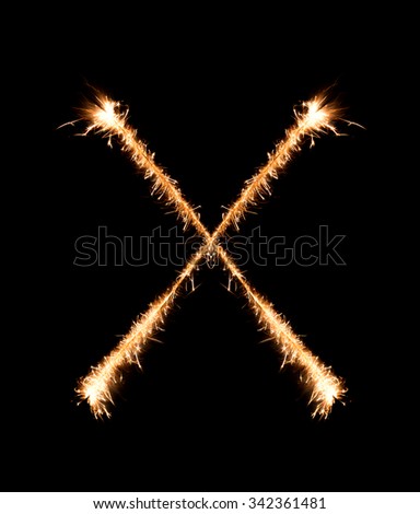 Sparkler firework light alphabet X at night background