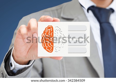 Businessman hand holding card with brain.