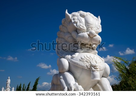 lion statue.White stone lion statue with blue sky