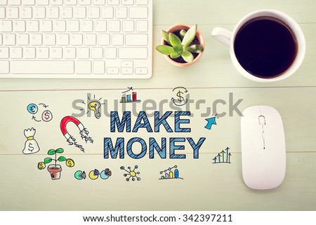 Make money concept with workstation on a light green wooden desk