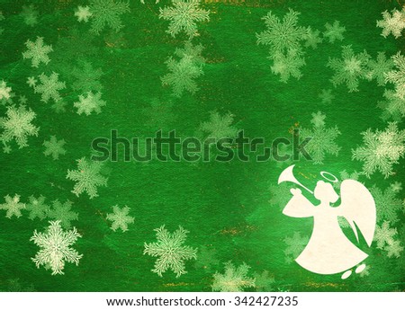 Horizontal grunge Christmas background of green color with snowflakes, angel  and paper texture 