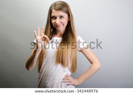 Portrait of a woman showing ok sign and smiling
