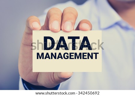 DATA MANAGEMENT, message on business card shown by a man, vintage tone