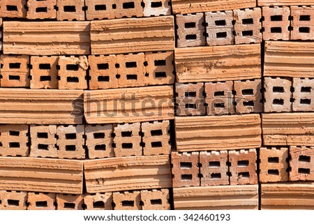 stack of red brick, raw material for house wall  