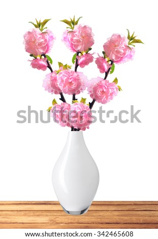 Almond Tree Flowers in vase on wooden table isolated on white