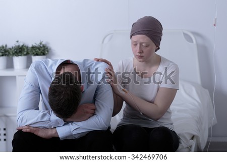 Picture of girl with cancer consoling her depressed dad