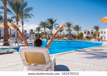 woman lying on a lounger by the pool. Relax on the sea