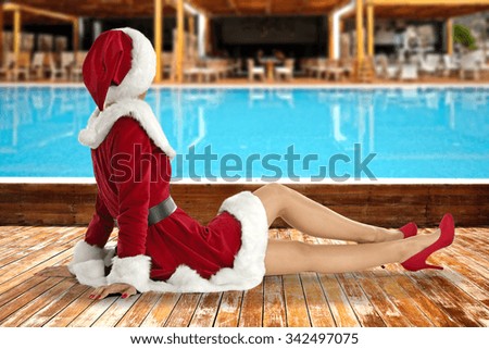 wooden terrace and swimming pool with slim woman 