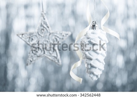 Silver and white Christmas ornaments on glitter bokeh background with space for text. Xmas and Happy New Year theme