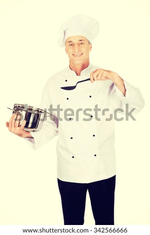 Restaurant chef holding steel pot and spoon
