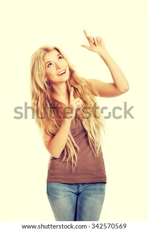 Happy student woman pointing up.