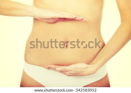 Beautiful woman cares for her belly.