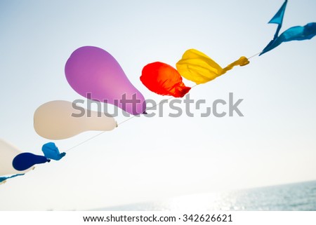 Colorful Baloon on the string near the sea with reverse light, empty image