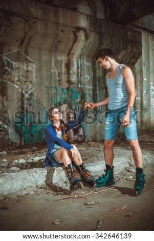 young roller couple on graffiti background 